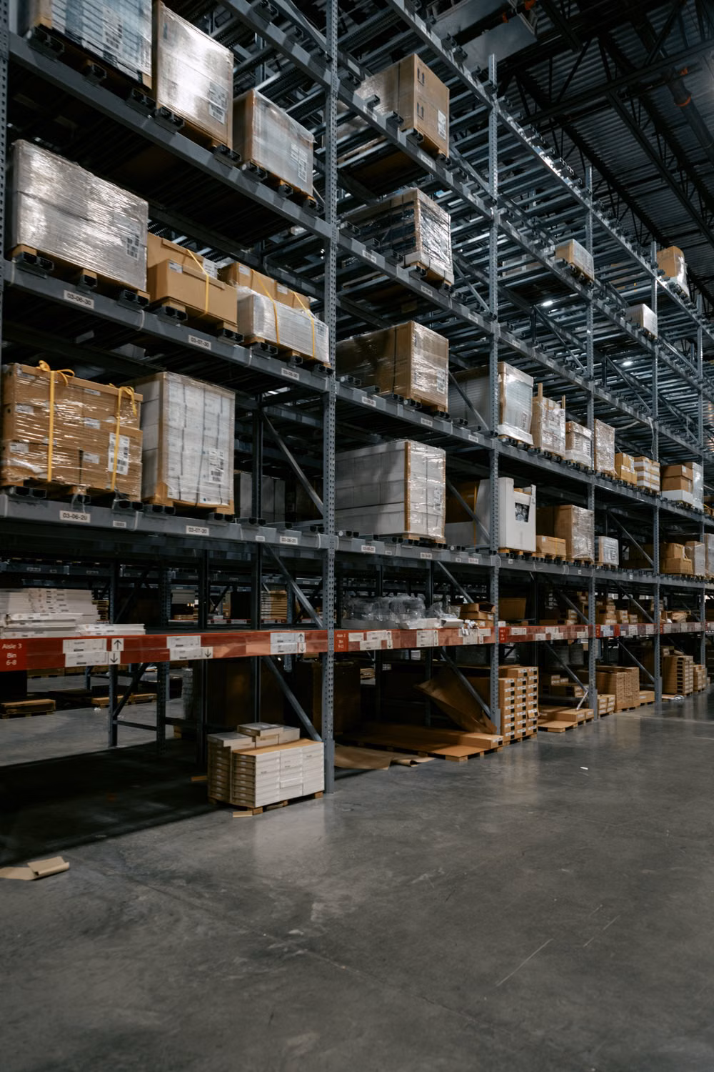 Organized racks inside a working warehouse