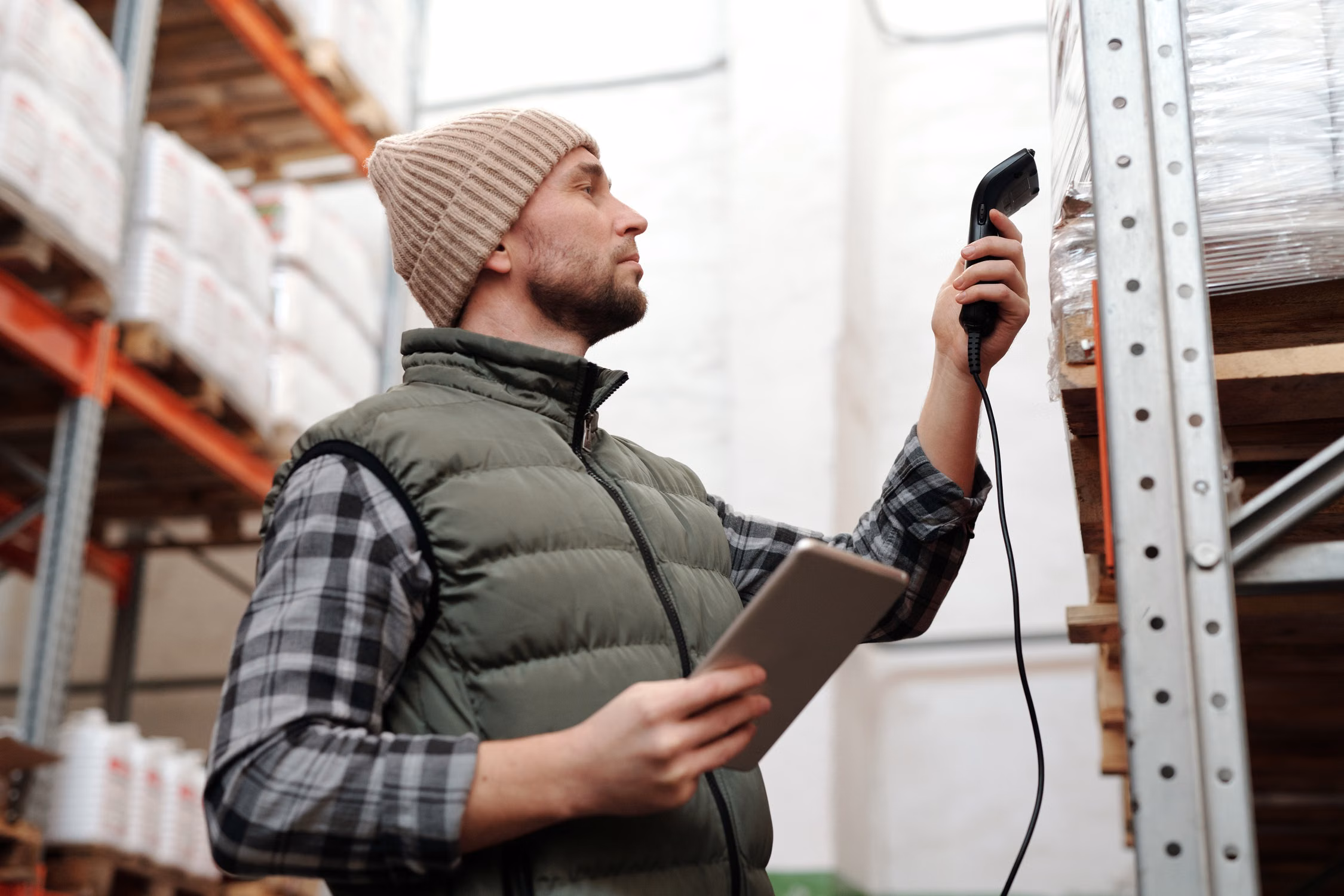 Warehouse worker checking packaged cargo